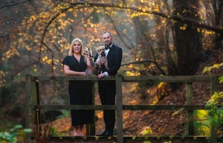 Husband and wife dressed to impress on their photoshoot with their two yorkshire terriers in Edinburgh